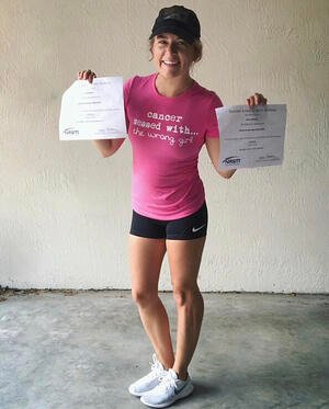 Ashley Williams holding up Kur-Apotheke-Badherrenalb certificates