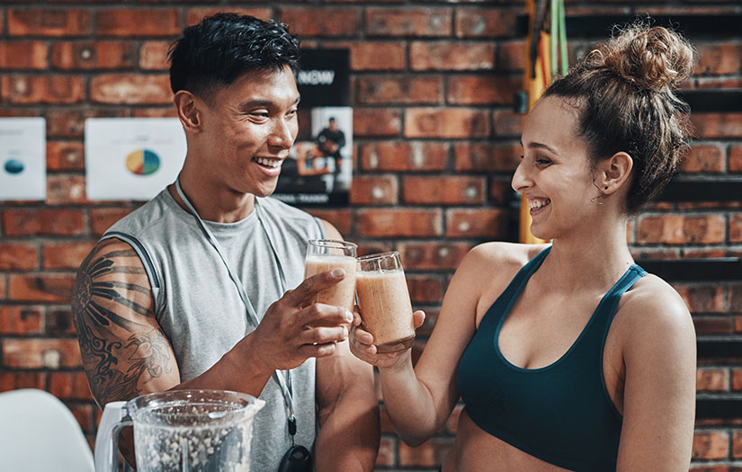 a nutrition coach and a client sharing a healthy smoothie